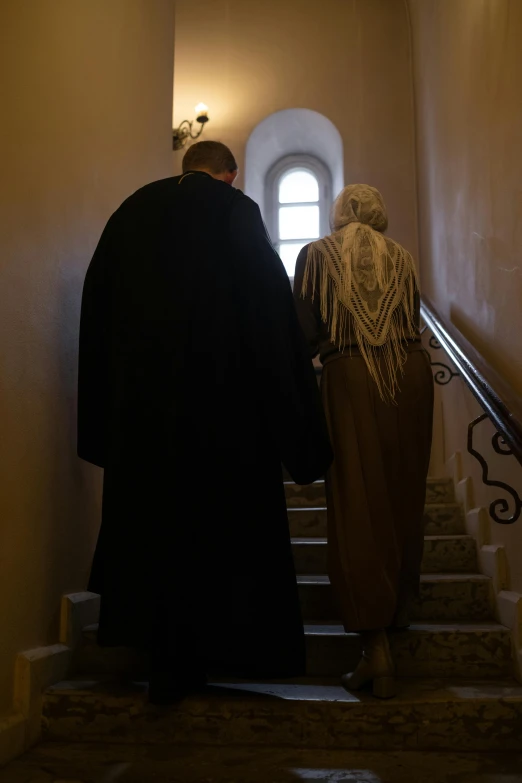 two men walking up the stairs of a stairwell