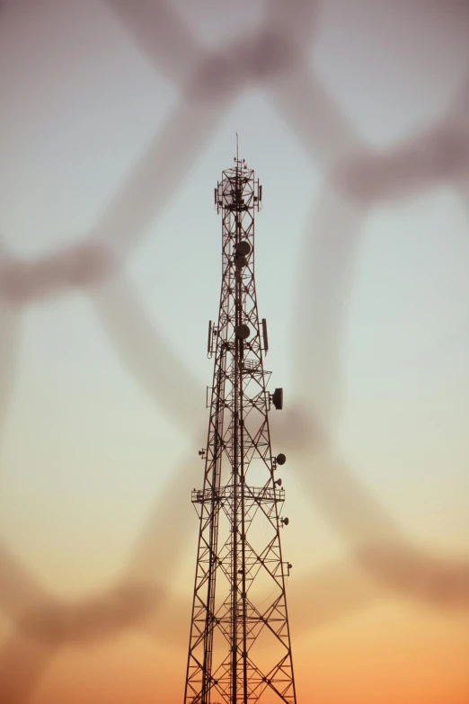 an image of the silhouettes of antennas against the sky