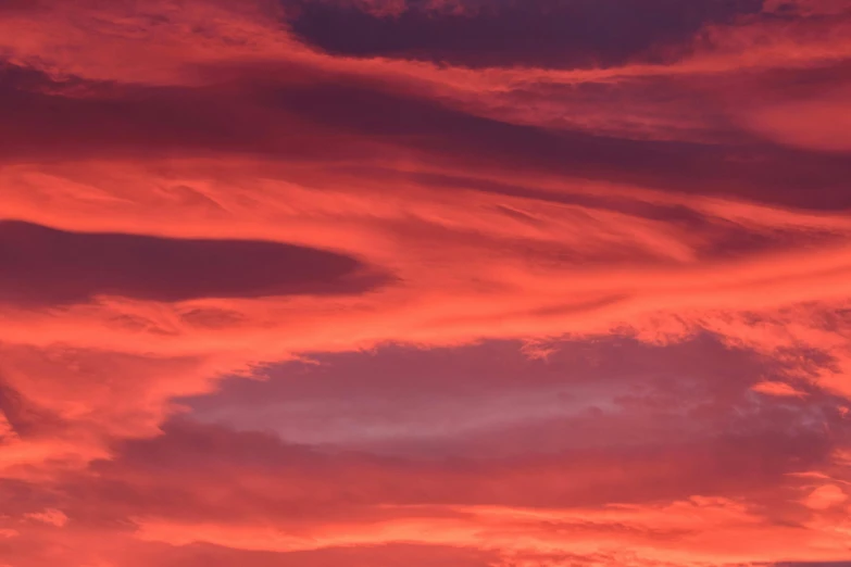 a red and purple cloudy sky at dusk