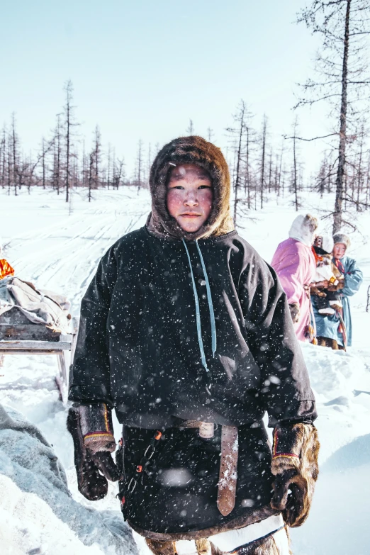 the man wearing a helmet and a coat stands in the snow