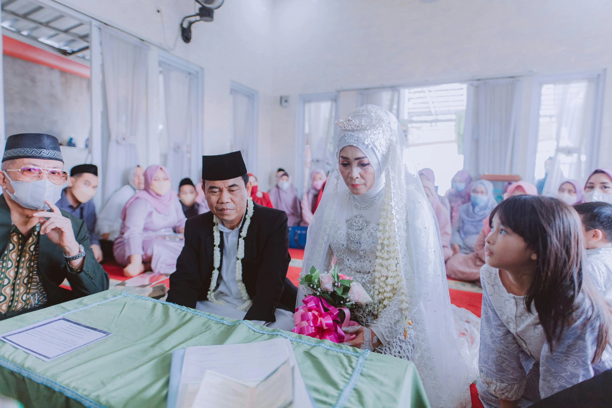 a bride and groom standing by the groom in a ceremony