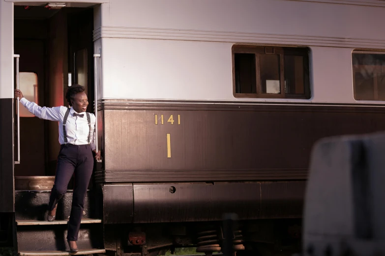 the woman stands on a platform of a train