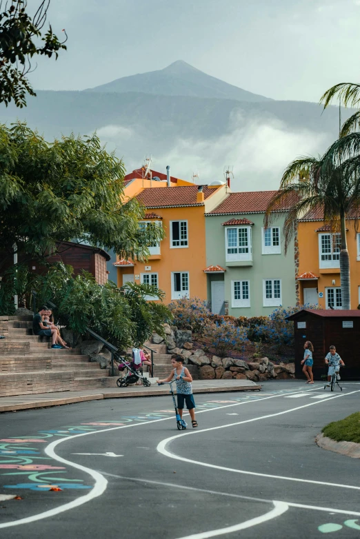 children playing basketball in the road with their parents