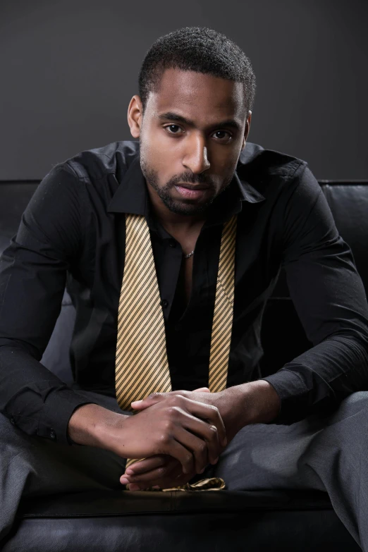 a black man wearing a dress shirt and neck tie