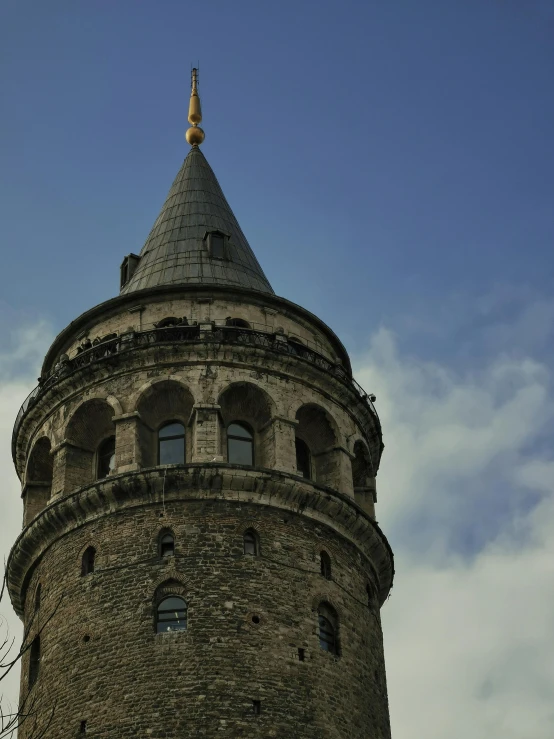 an old tower with a weather vane on top of it