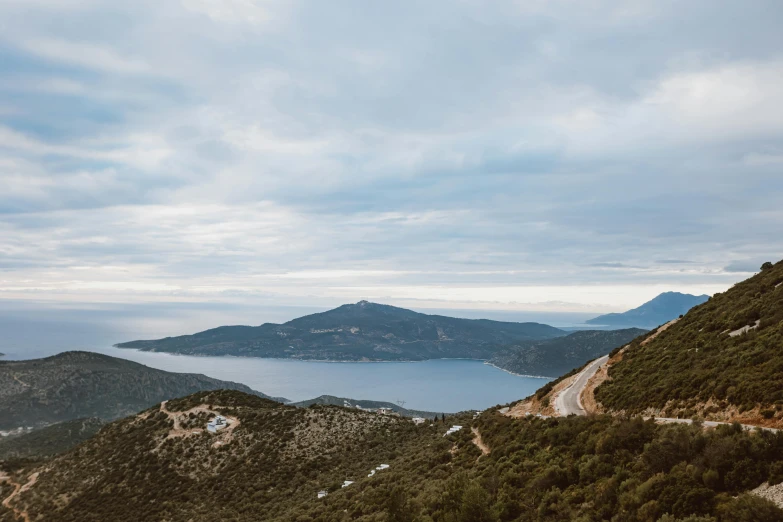 a view from the top of a mountain overlooking a lake and mountains