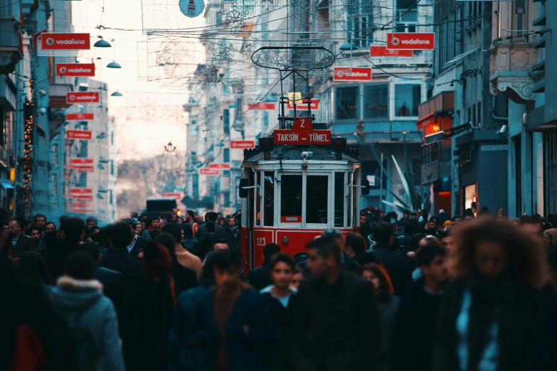 a crowded street with lots of pedestrians and streetcars