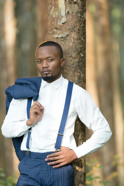 a man wearing a blue bow tie and suspenders