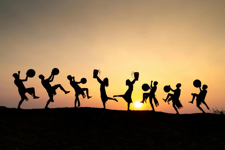 silhouetted children jumping into the air and on the ground