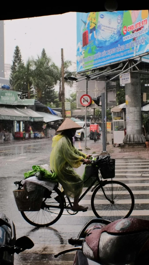 a woman sitting on top of a bicycle in the rain