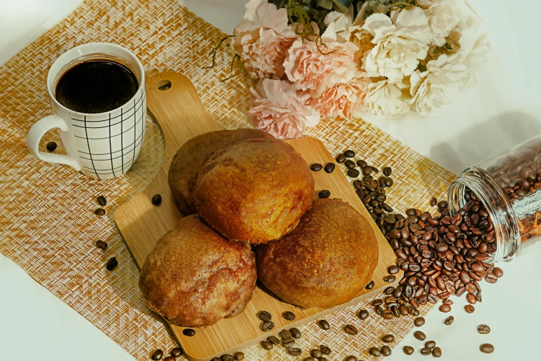 the breads are on the  board next to some beans