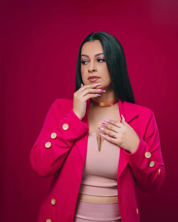 the woman is posing for a po wearing a bright pink jacket