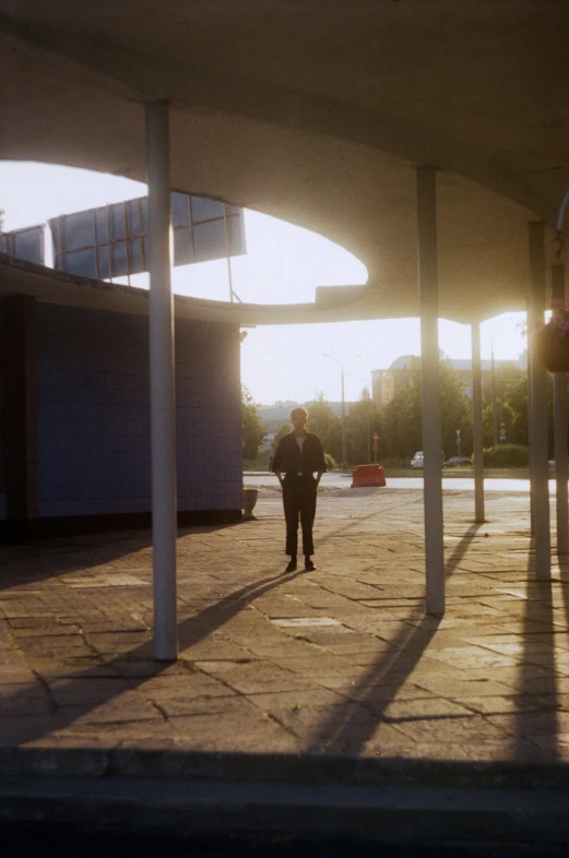 the back of an empty parking lot with two men walking