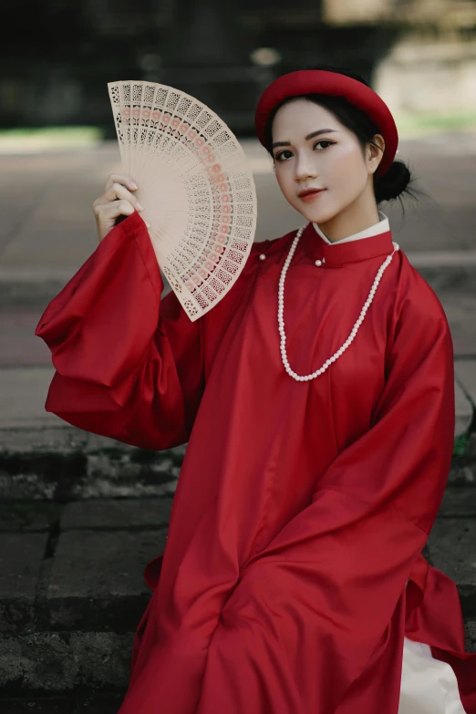 an asian woman with a dress and hat