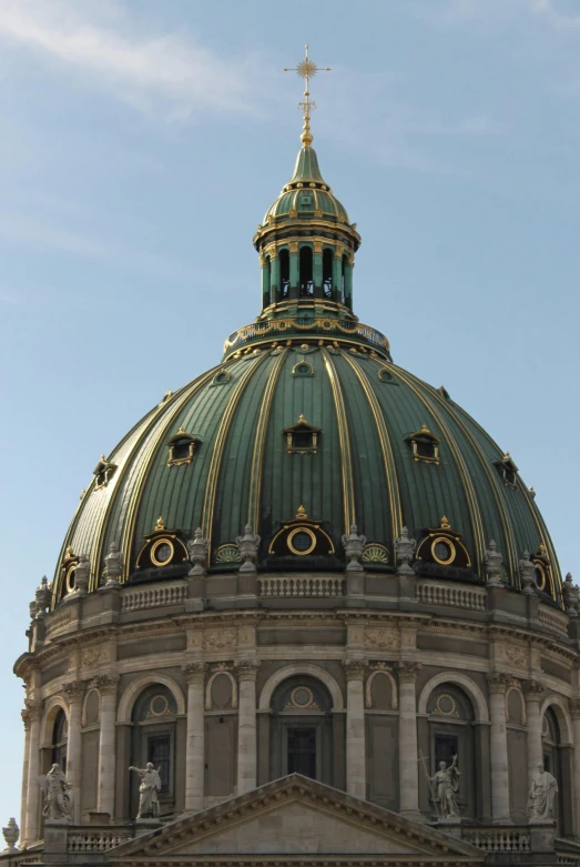 a closeup po of a dome with statues on it