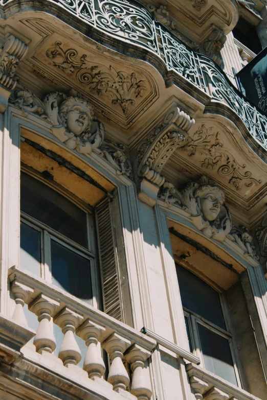 an architectural structure in the city with clock and balcony