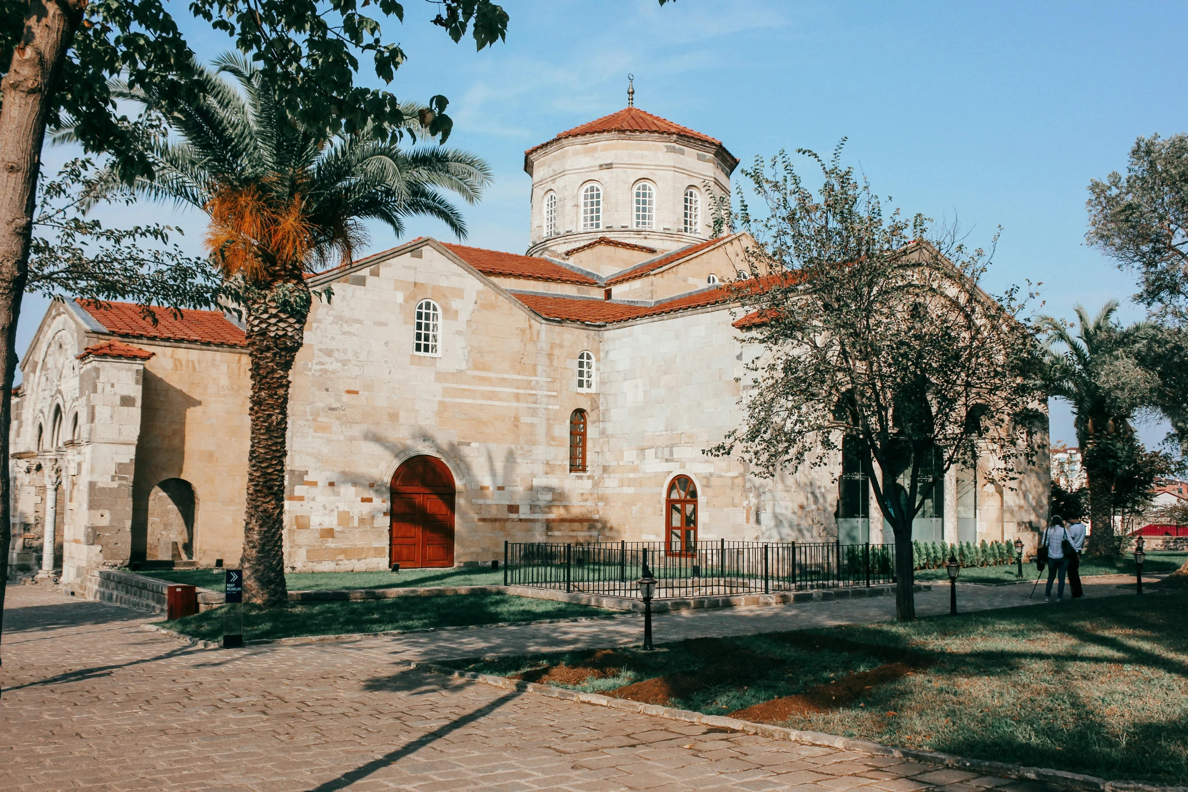 the church is made of stone and has a red door