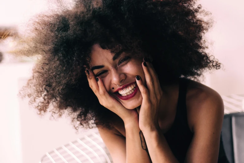 a smiling woman is sitting on a bed