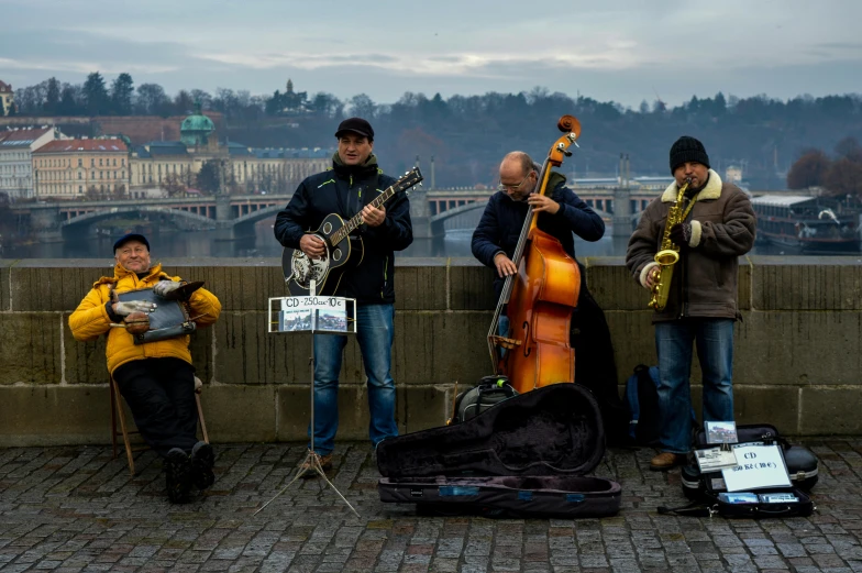a group of musicians stand together while one plays a musical instrument
