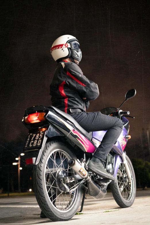 a person on a parked motorcycle with a helmet