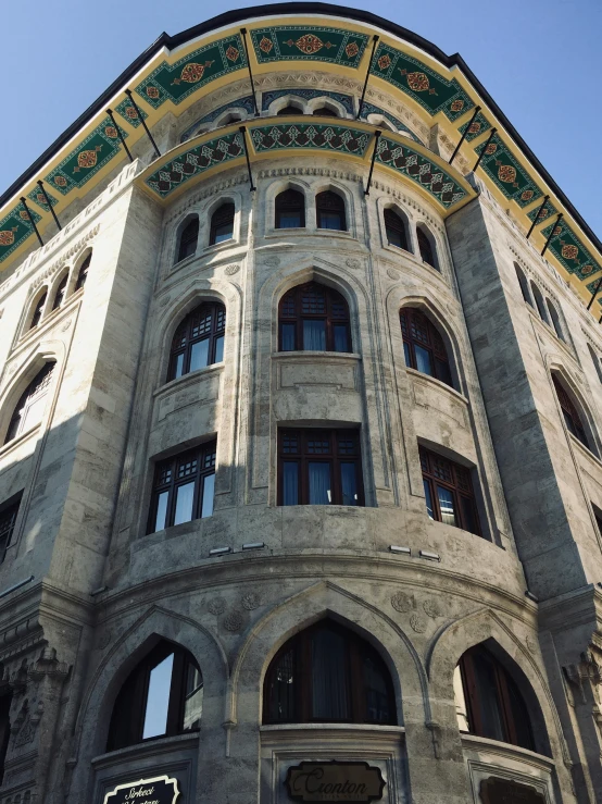 a building with an elaborately designed roof and green trim