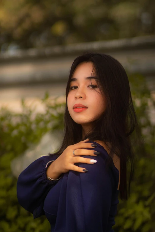 a young woman stands and poses for the camera