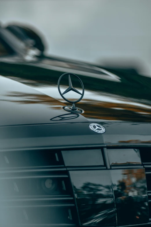 the mercedes logo is on the hood of the car