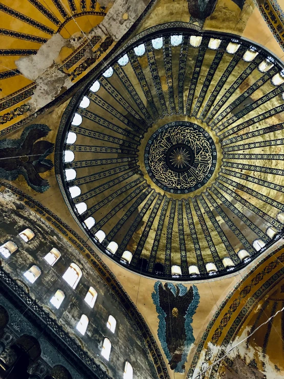 the ceiling of a large building with ornate gold and blue paint