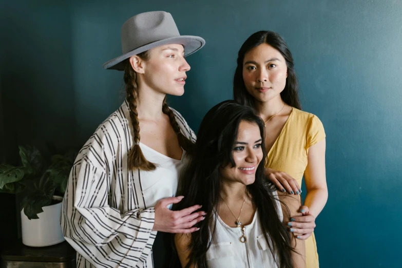 a woman is shown between two women with one leaning against the wall