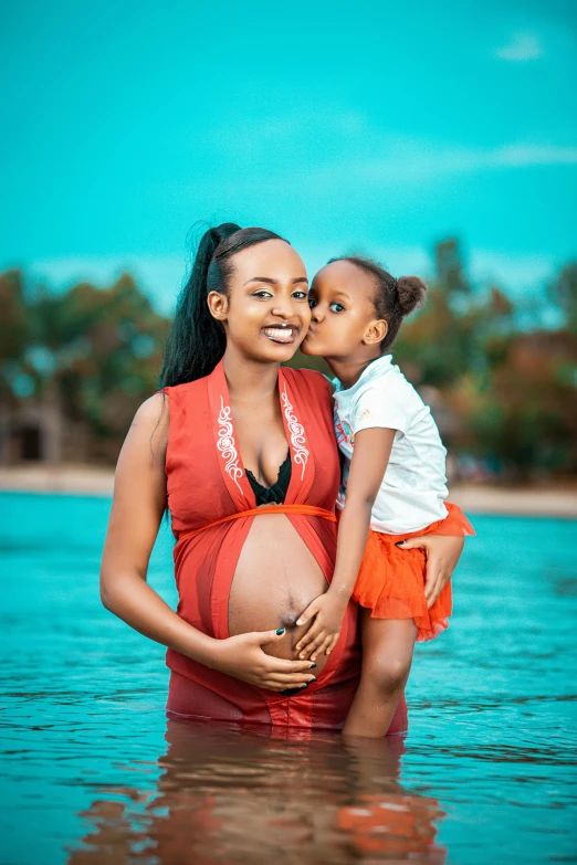 pregnant woman and  pose for a po in the water