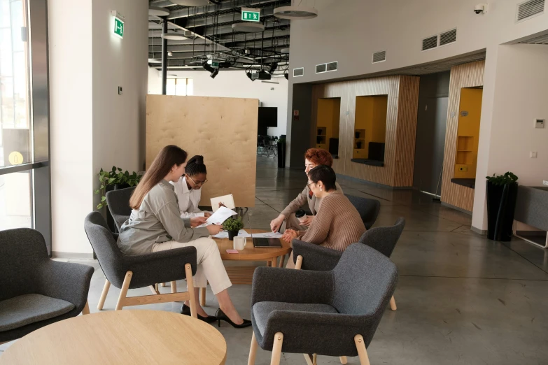 some people sit on two different couches in an office