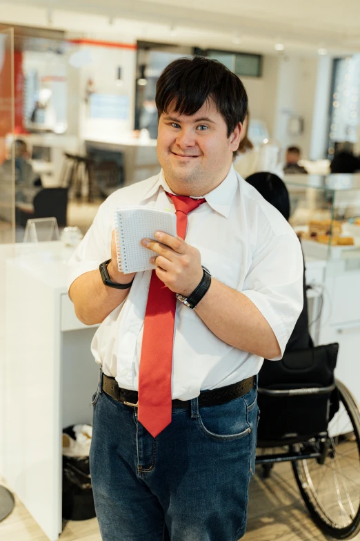 a man is standing inside and holding up a piece of paper