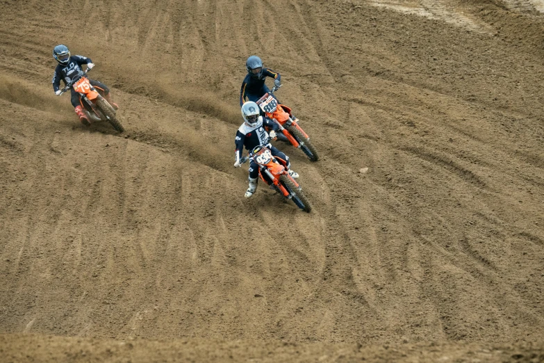 two people on dirt bikes in the middle of the desert