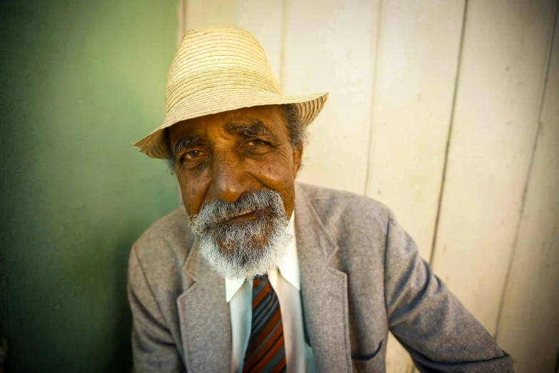 an elderly man with a hat and a beard