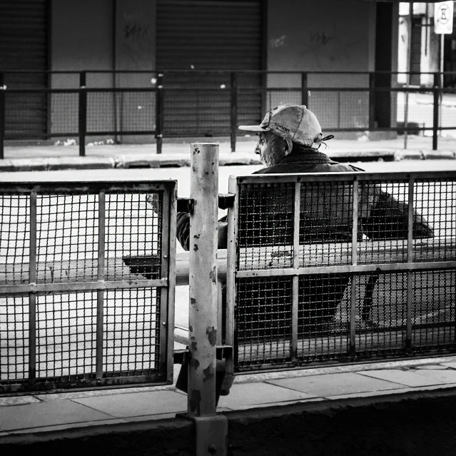 people are standing behind some cages at a zoo