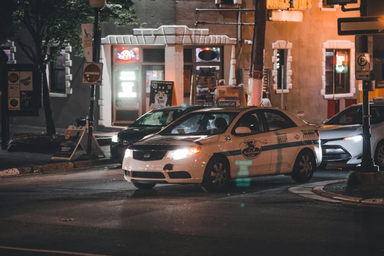 a police car is parked on the street at night