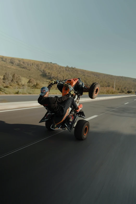 a man riding a four wheeler with large tires