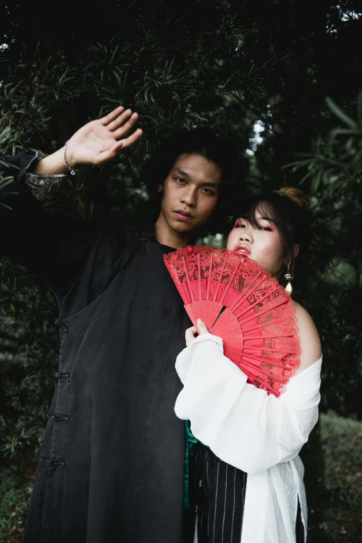 a couple is posing with their hands on their cheek