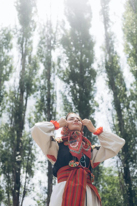 a young woman with traditional costume in the forest