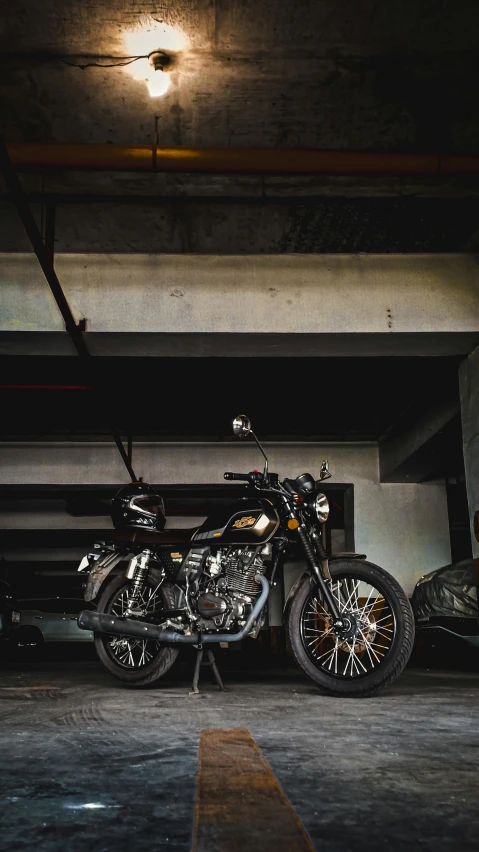 a motorbike parked underneath an overpass in a parking garage