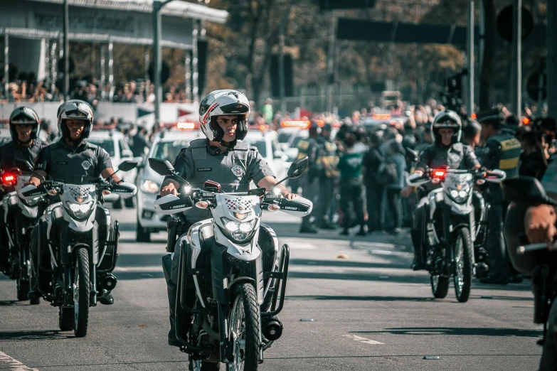 group of motorcycle riders on a city street