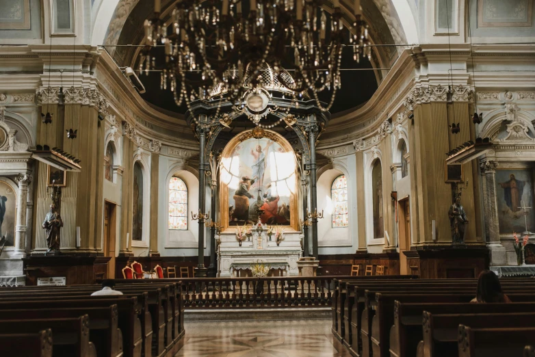 a couple of church pews in front of the alter