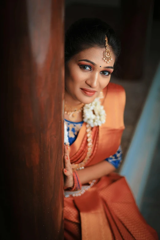 a beautiful woman in an orange sari