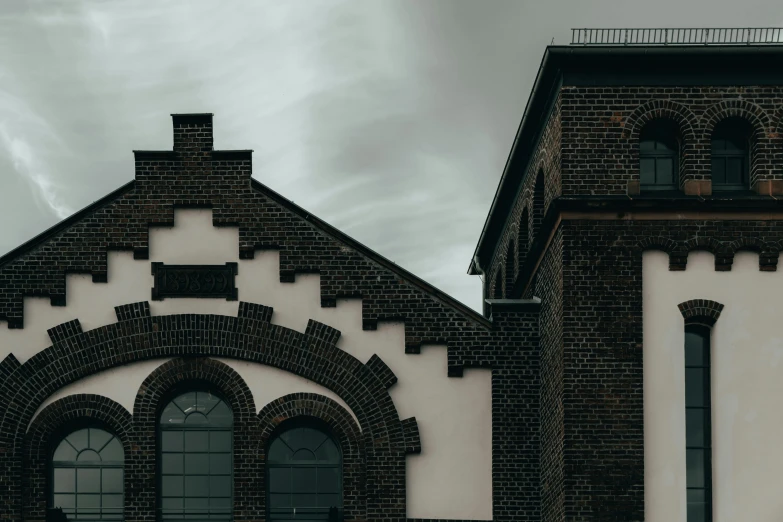 an old building has two arched windows and a clock on it