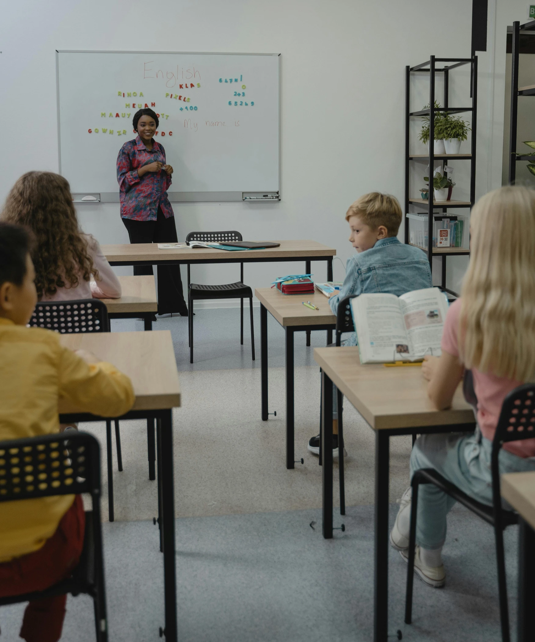 children are in a classroom that has a chalkboard