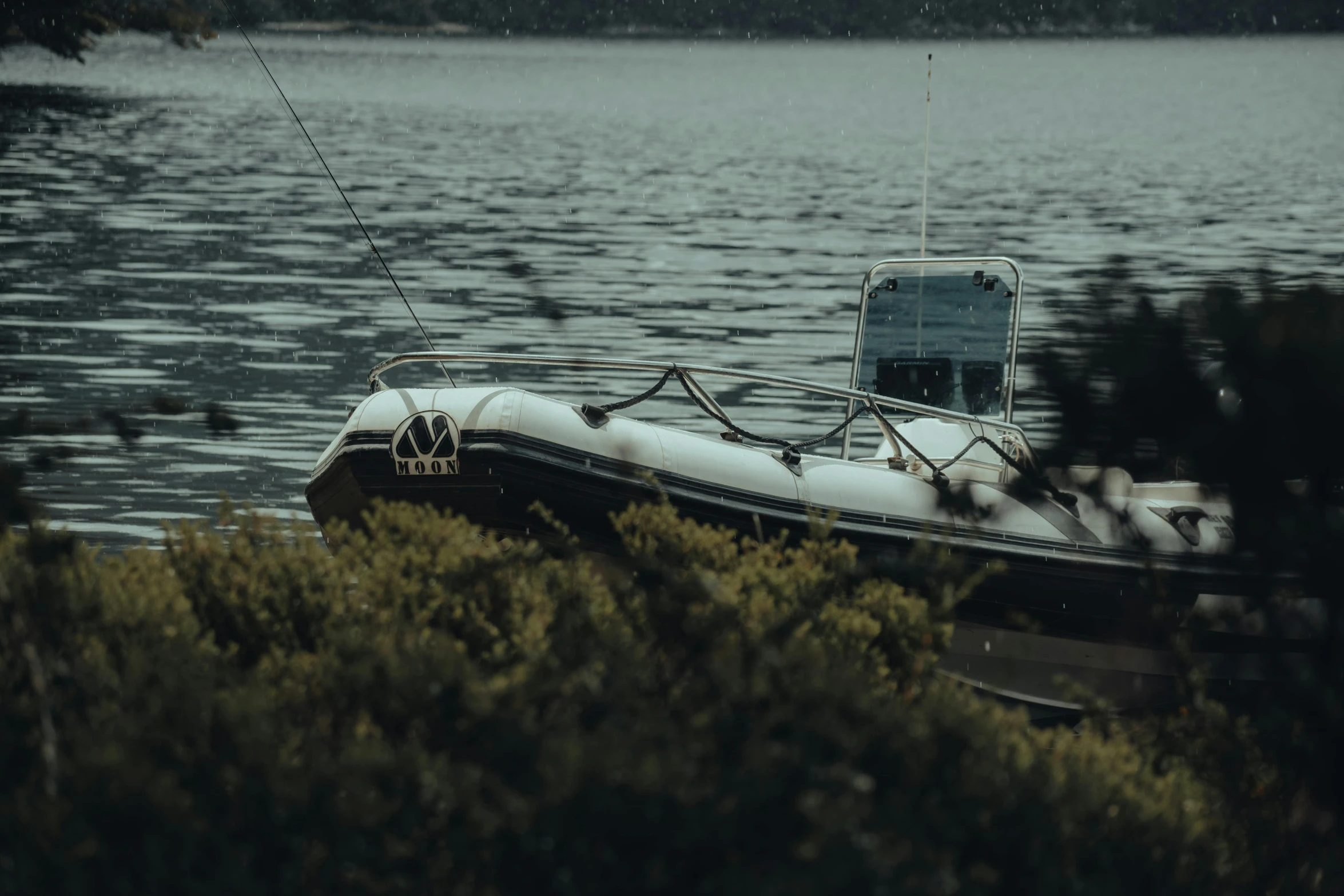 a small boat on the shore next to the water