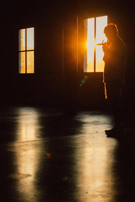 a man that is standing in front of a window