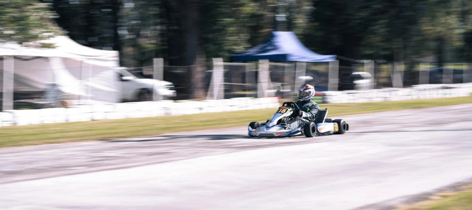 a person riding a kart racing bike on a race track