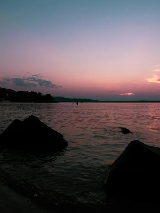 the sun setting over a body of water