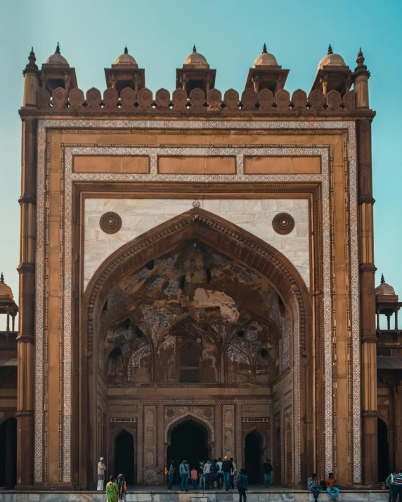 people are standing outside of a building near water